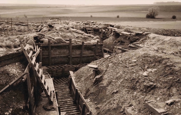 A black and white photo of empty war trenches.