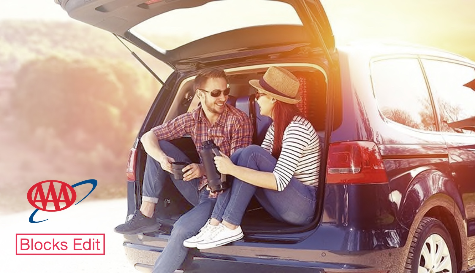 A couple on a road trip, takes a break to have some coffee from a thermos in the back of their SUV.